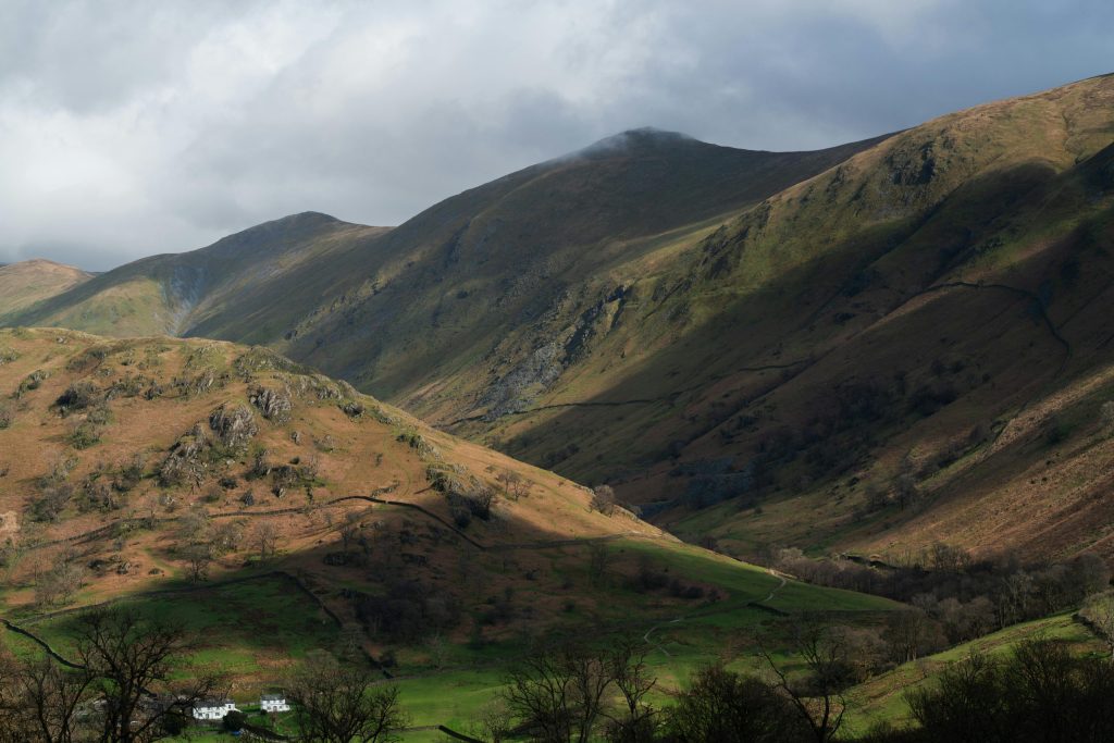 Scenic view of rolling hills in the Lake District. Cloudy grey skies