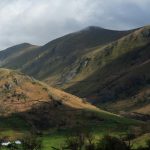 Scenic view of rolling hills in the Lake District. Cloudy grey skies