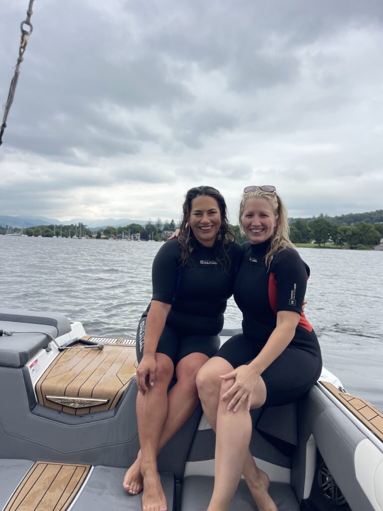 Claire and Jojo sat on Nautique boat on lake windermere